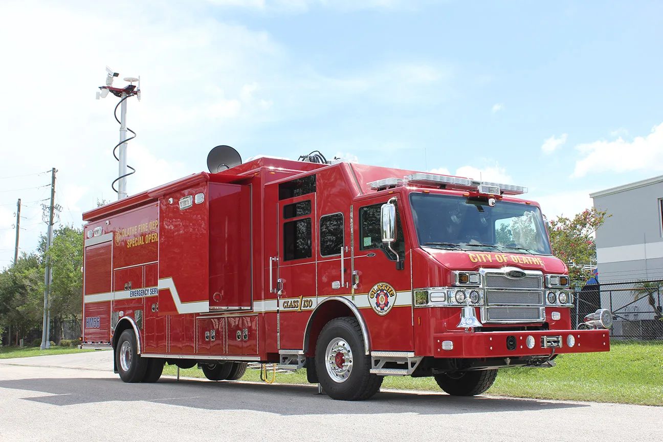 EOD Bomb unit for Olathe Fire Department parked outside near the Frontline Communications building on a sunny day.