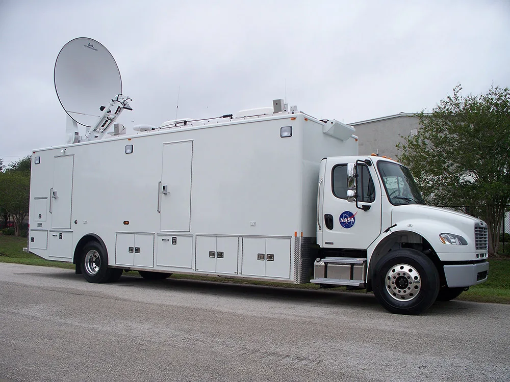 NASA C-40 Test Measurement vehicle parked outside on a cloudy day.