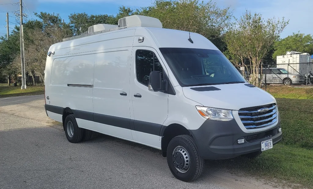 Frontline Communications Hostage Negotiation vehicle parked outside on the street on a sunny day.