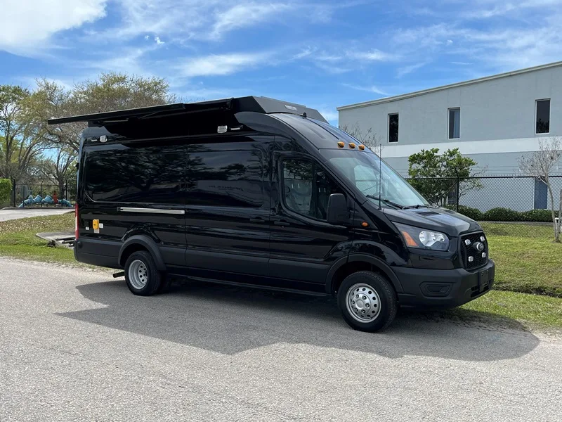 C-22 Crisis Negotiation vehicle parked outside the Frontline Communications building on a sunny day.