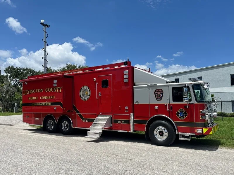 Lexington County Fire Department's Mobile Command vehicle parked outside near the Frontline Communications building on a sunny day.