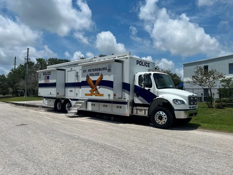 Frontline Communications C-40X-4 Mobile Command vehicle for St. Petersburg Police Department parked outside near the building on a cloudy day.