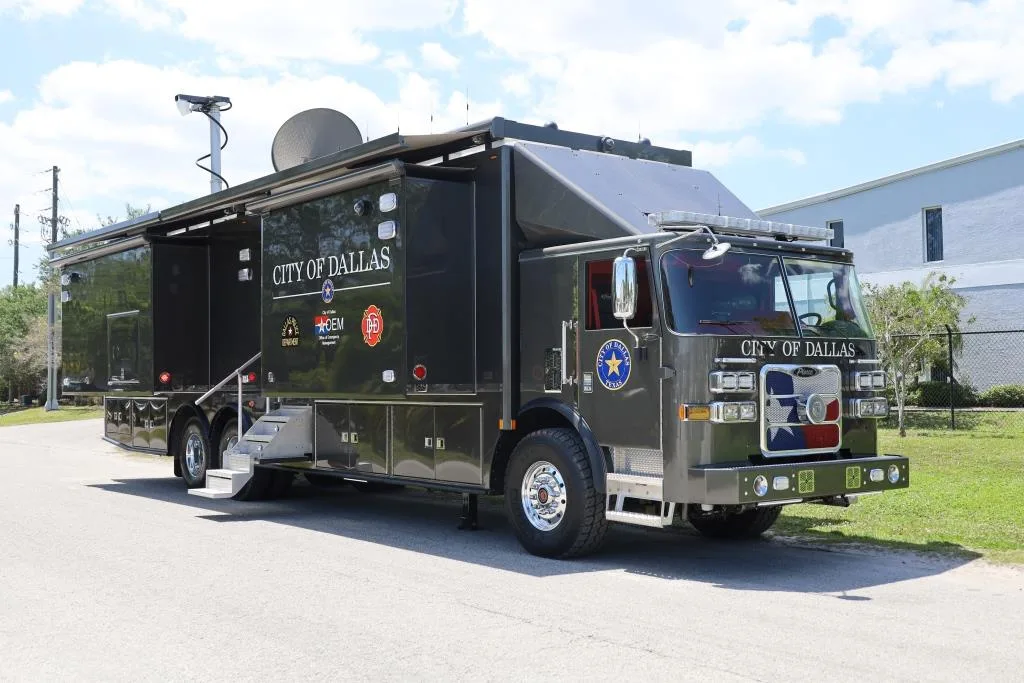 Frontline Communications C-45X-4 Mobile Command vehicle parked outside the building on a cloudy day.