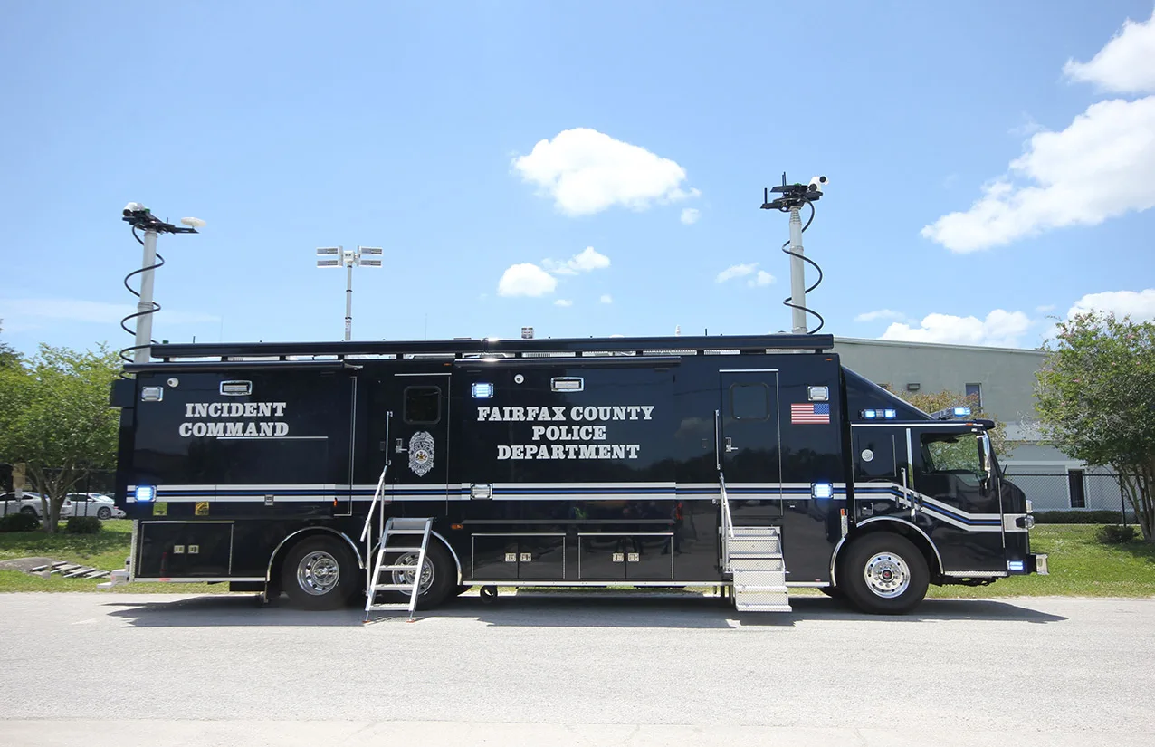 Frontline Communications C-43X-4 Incident Command vehicle for Fairfax Police Department parked outside near the building on a sunny day.