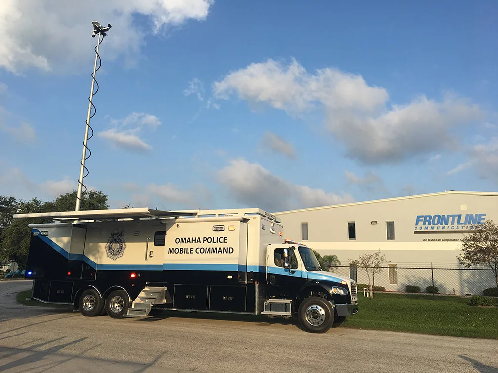 Frontline Communications C-42X-3 Mobile Command vehicle for Omaha Police Department parked outside near the building on a sunny day.