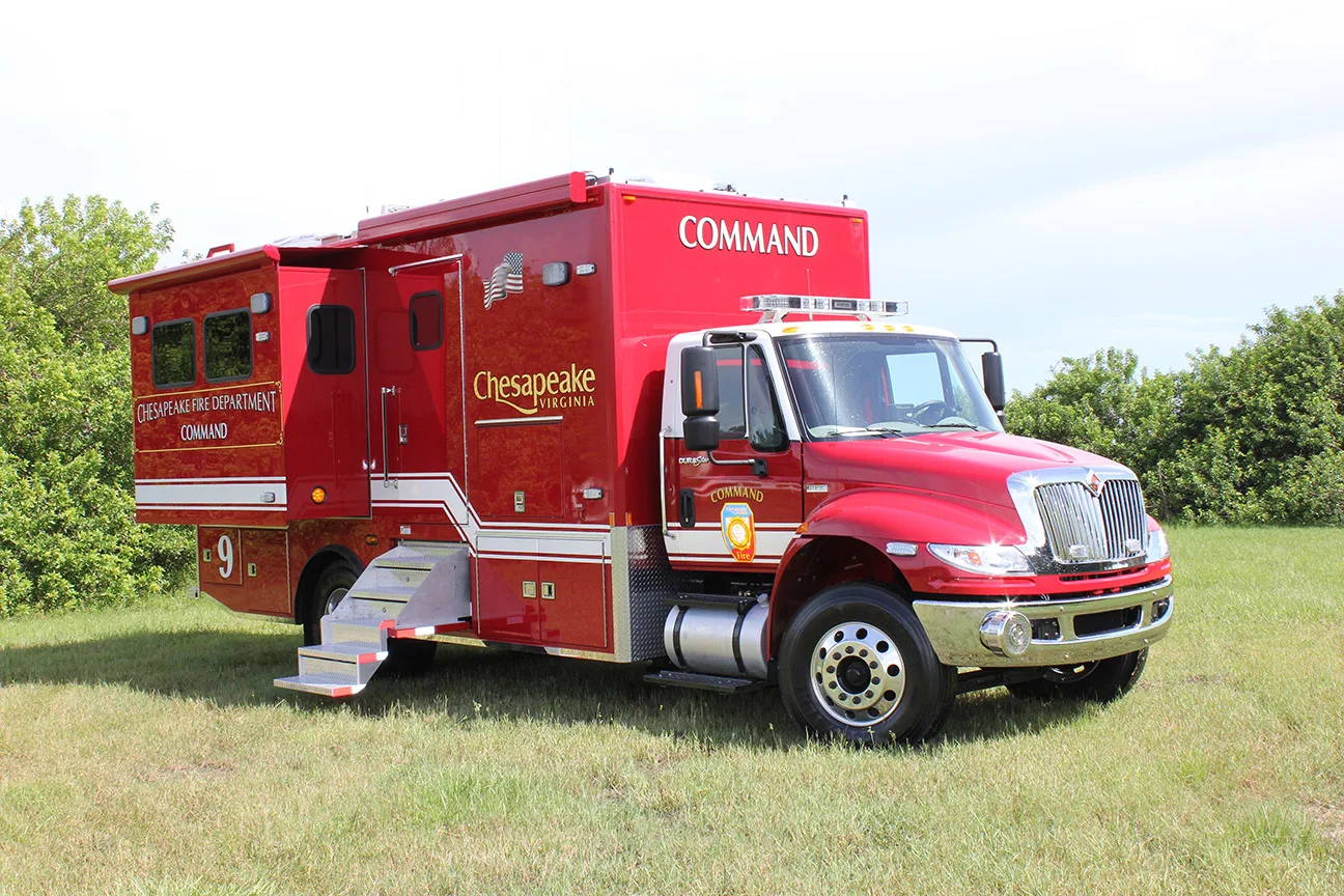 C-30X Mobile Command Center parked outside in the grass on a cloudy day.
