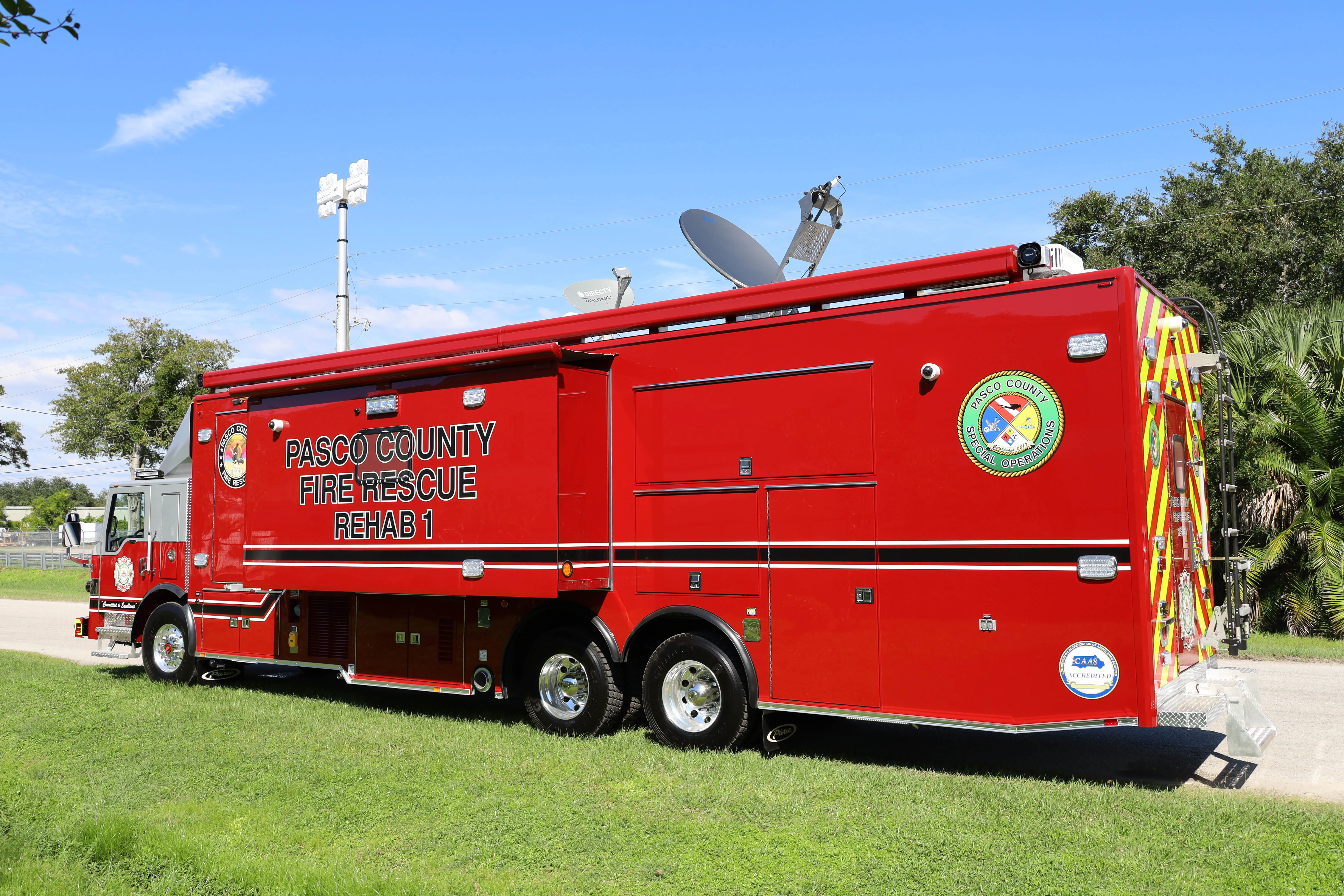 Frontline Communications C-45X-2 Rehab unit parked outside on a sunny day.