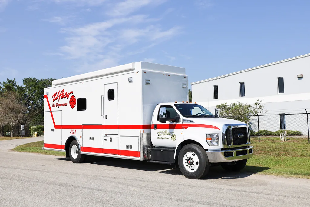 C-35 Rehab unit parked outside near the Frontline Communications building on a sunny day.