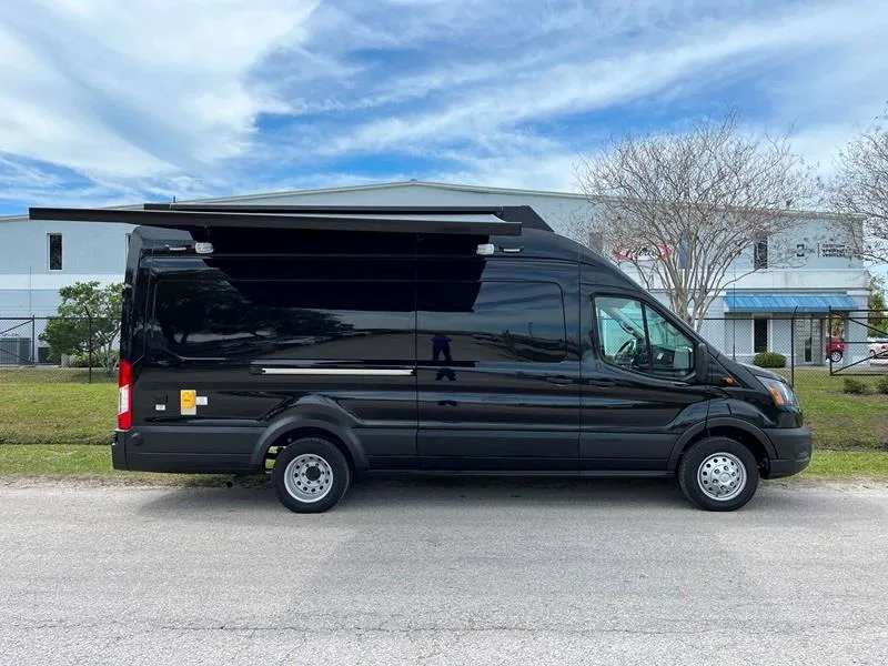 Peoria PD C-22 Small Mobile Command vehicle parked outside of the Frontline Communications building on a cloudy day.