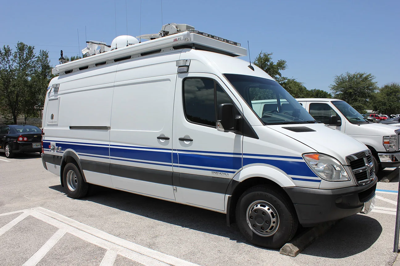 Frontline Communications C-23 Small Mobile Command vehicle parked outside in a parking lot on a sunny day.