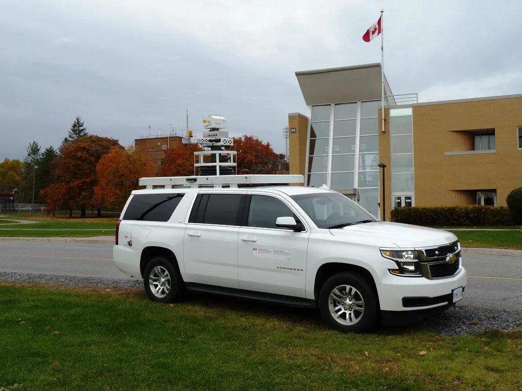 Frontline Communications C-17 Mobile Command Center parked outside in front of a building on a cloudy day.