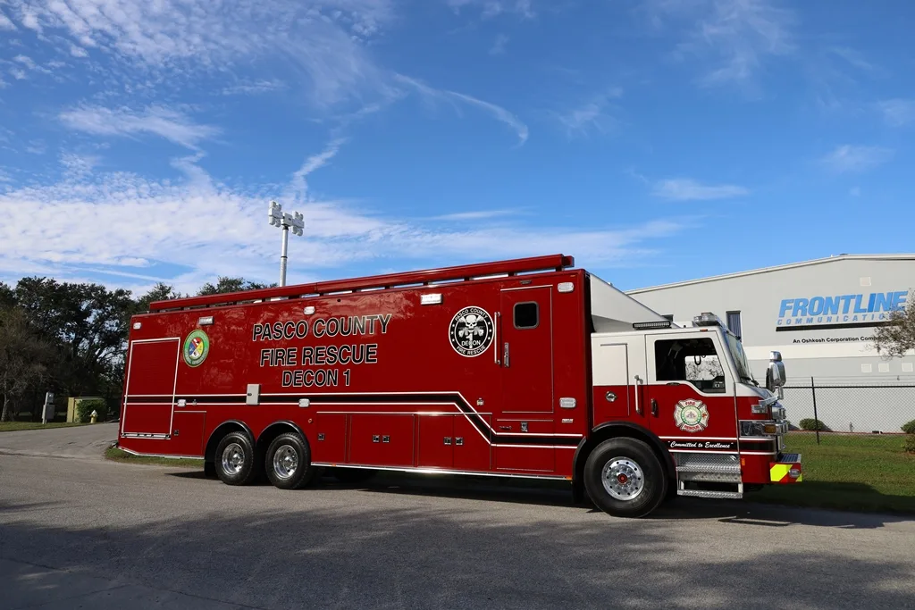 Pasco County Fire Rescue C-40 Decon Specialty Vehicle parked outside of the Frontline Communications building on a sunny day.