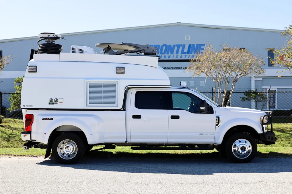San Bernadino County Fire Department Specialty vehicle parked outside of the Frontline Communications building on a sunny day.