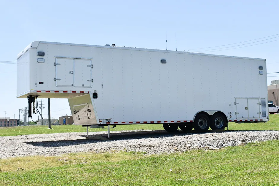 Frontline Communications Specialty Vehicle for North Texas Municipal Water District parked outside on a gravel road near grass on a sunny day.