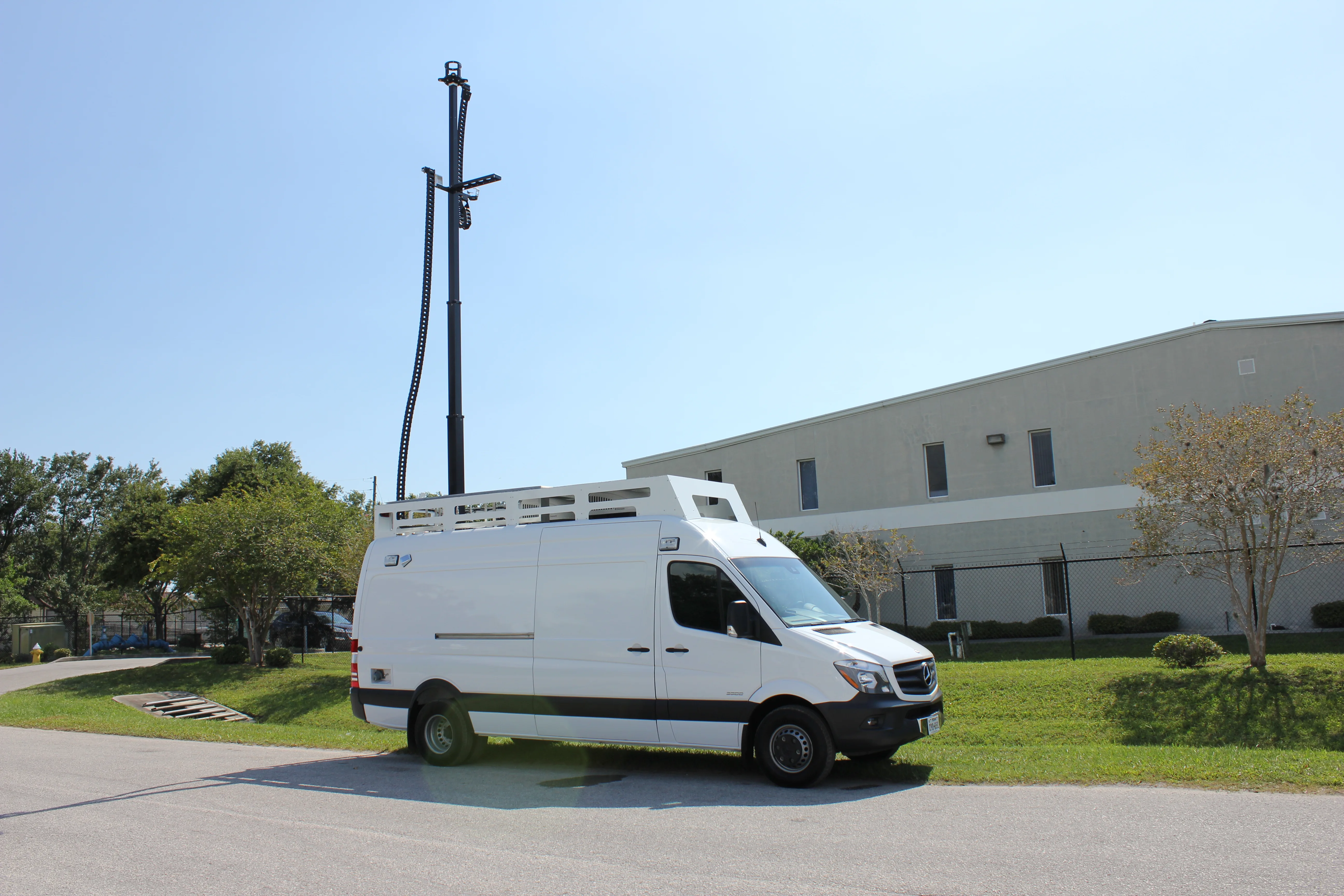 Frontline Communications C-24 Specialty vehicle parked outside on a sunny day.