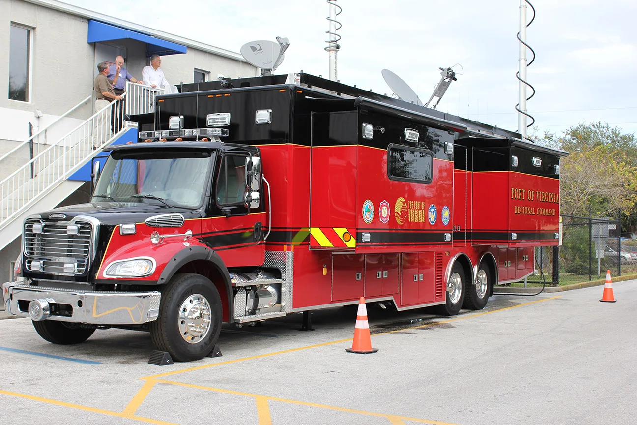 VA Port Authority Mobile Command vehicle technology refurbishment parked outside of the Frontline Communications building on a cloudy day.