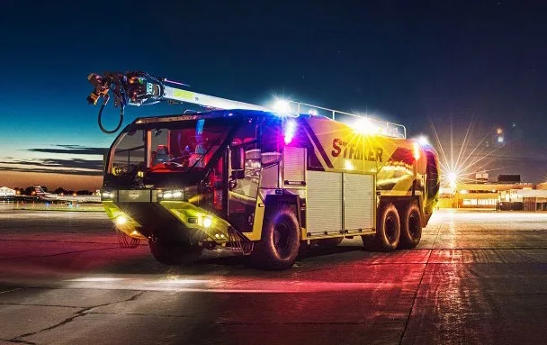 Oshkosh Striker ARFF vehicle on the runway at night
