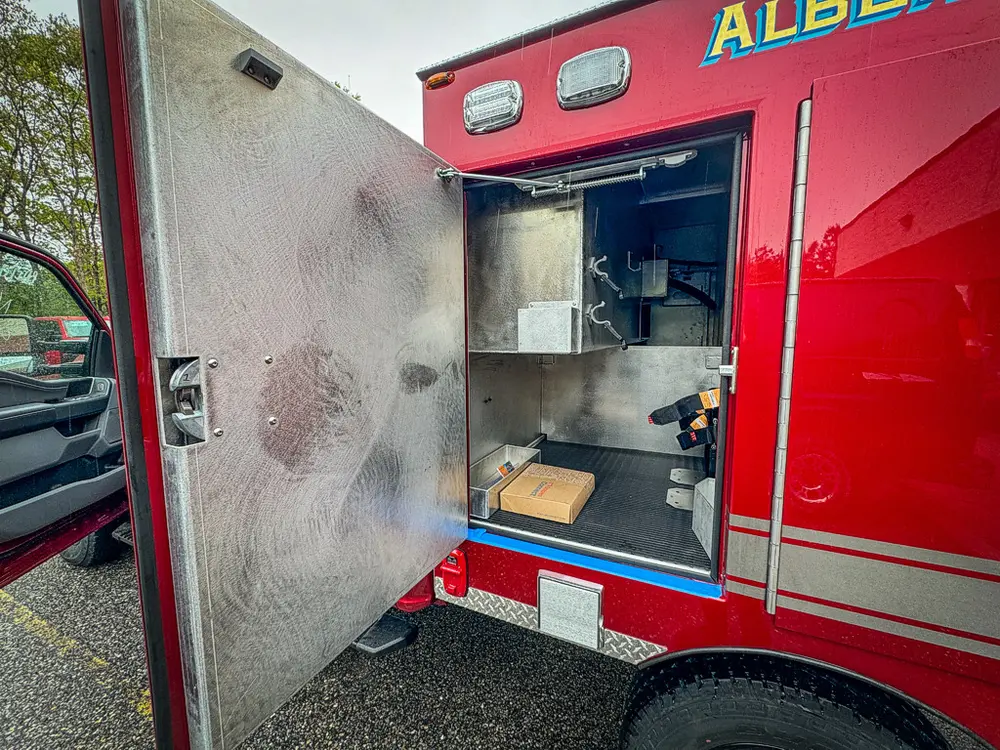 Open side compartment with shelves and interior lining.