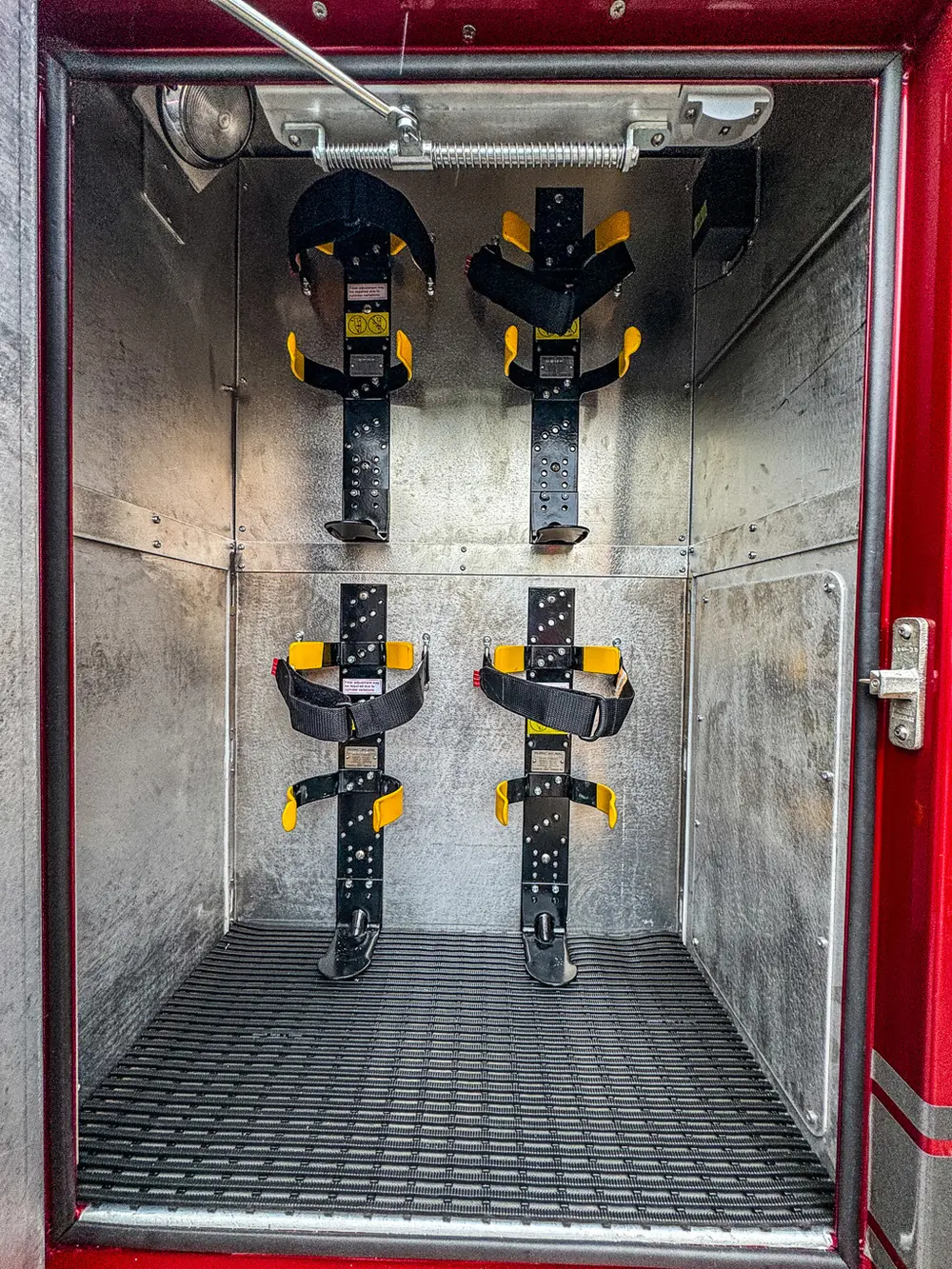 Tool mount rails and clamps on compartment wall.