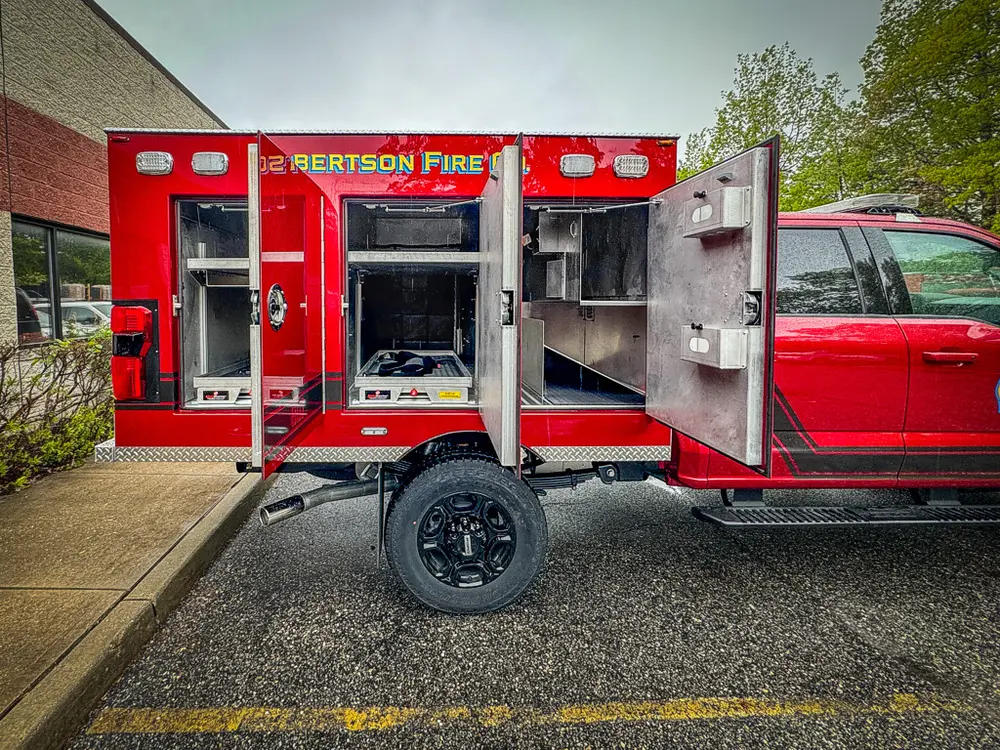 Wide rear side view with multiple compartments open.