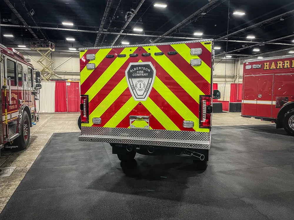 Straight rear view with chevron rear doors and center badge.