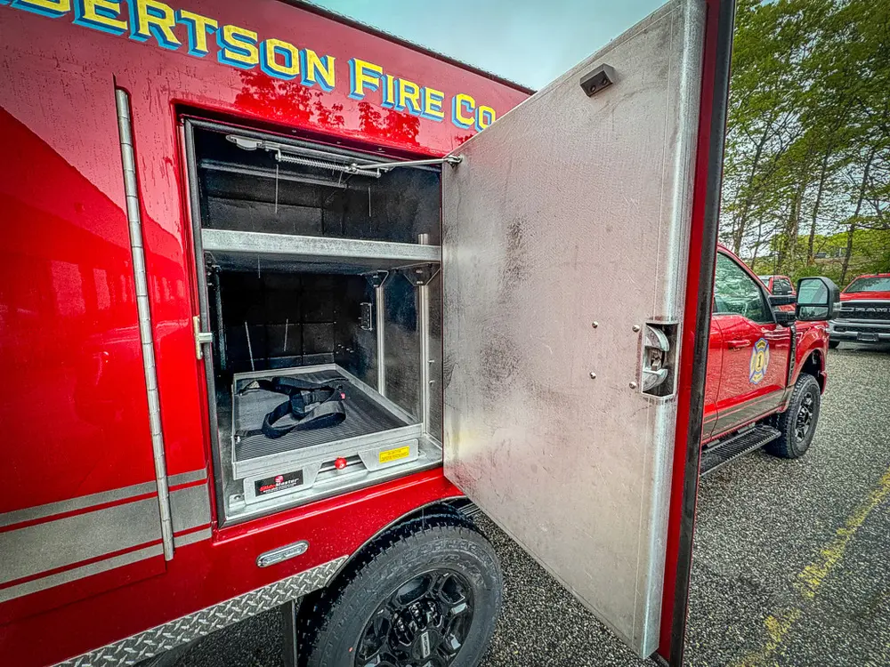 Open side compartment door with side body lettering visible.
