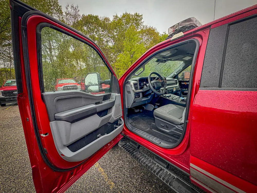 Open front passenger door showing cabin entry and seat.