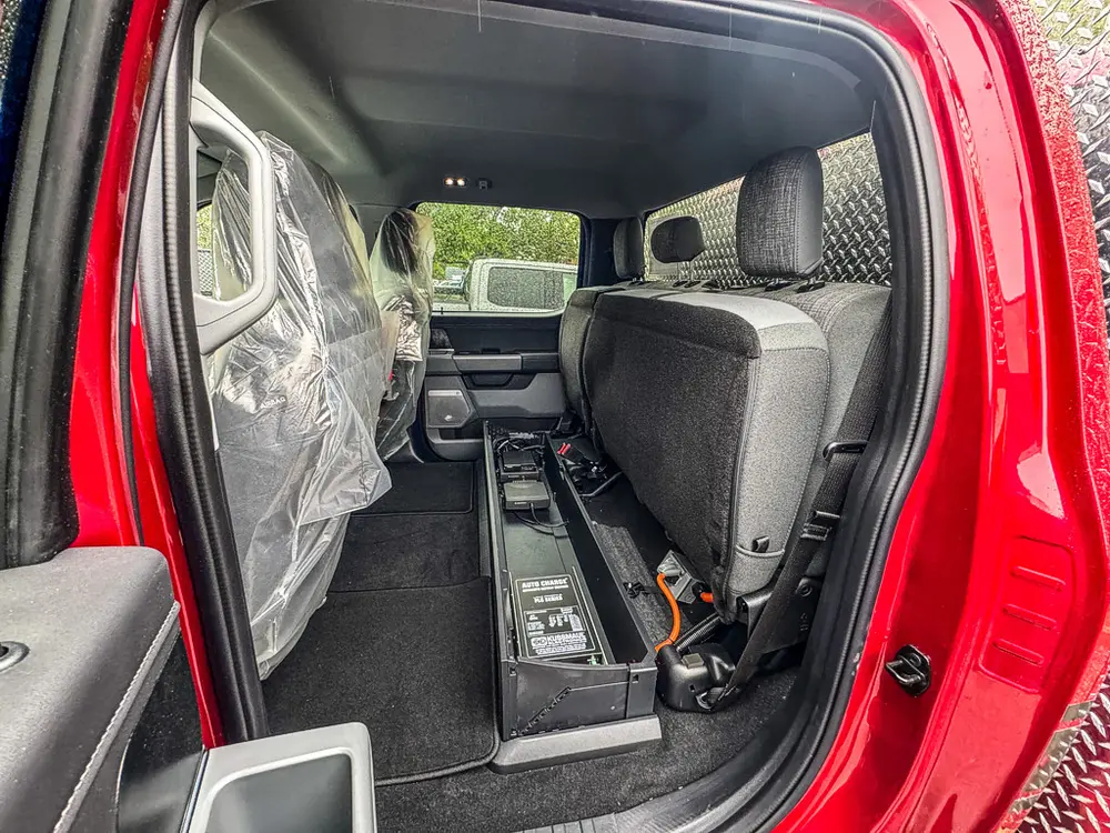 Rear cabin floor area and equipment track behind front seats.
