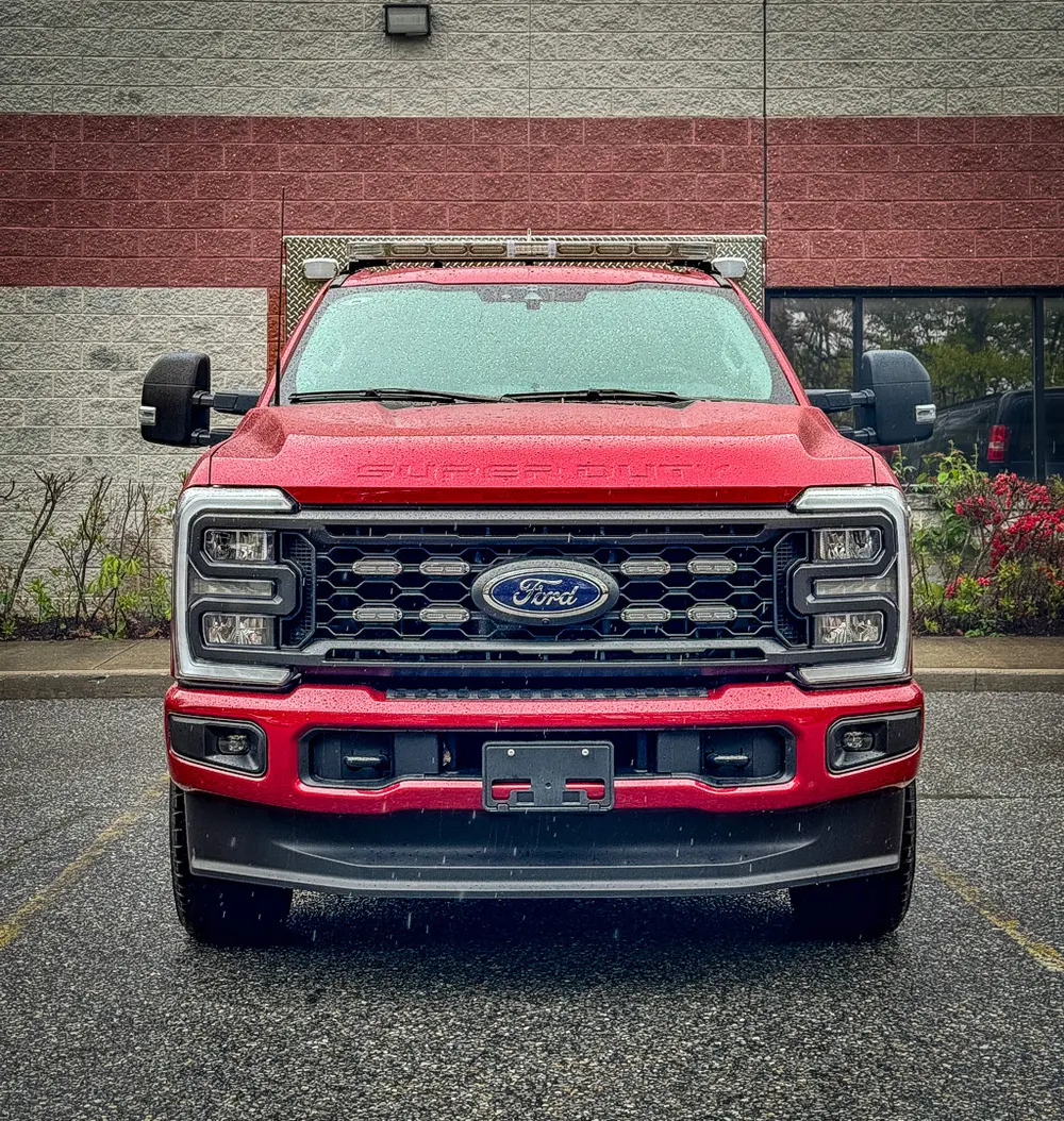 Head-on front outdoor view with grille and hood.