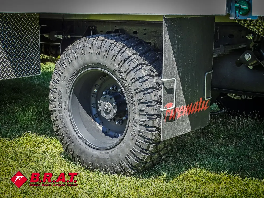 Rear tire close-up with mudflap and utility body edge.