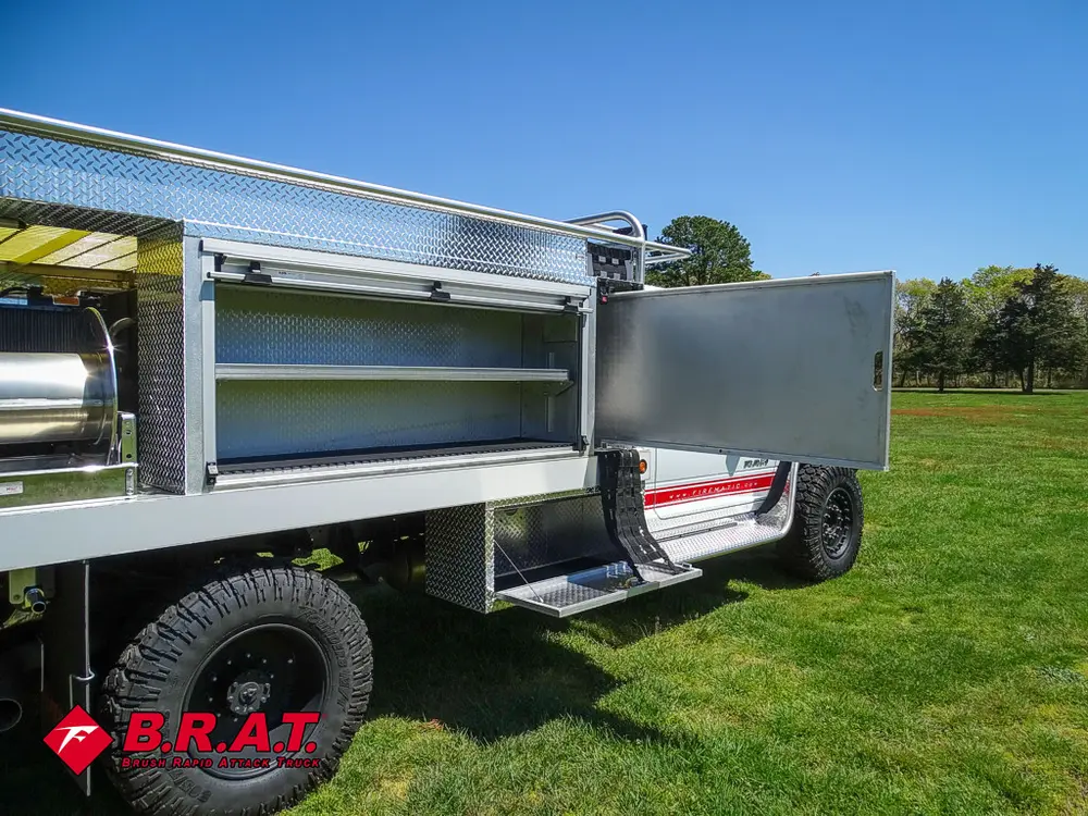 Passenger-side rear compartment open with long shelf tray.