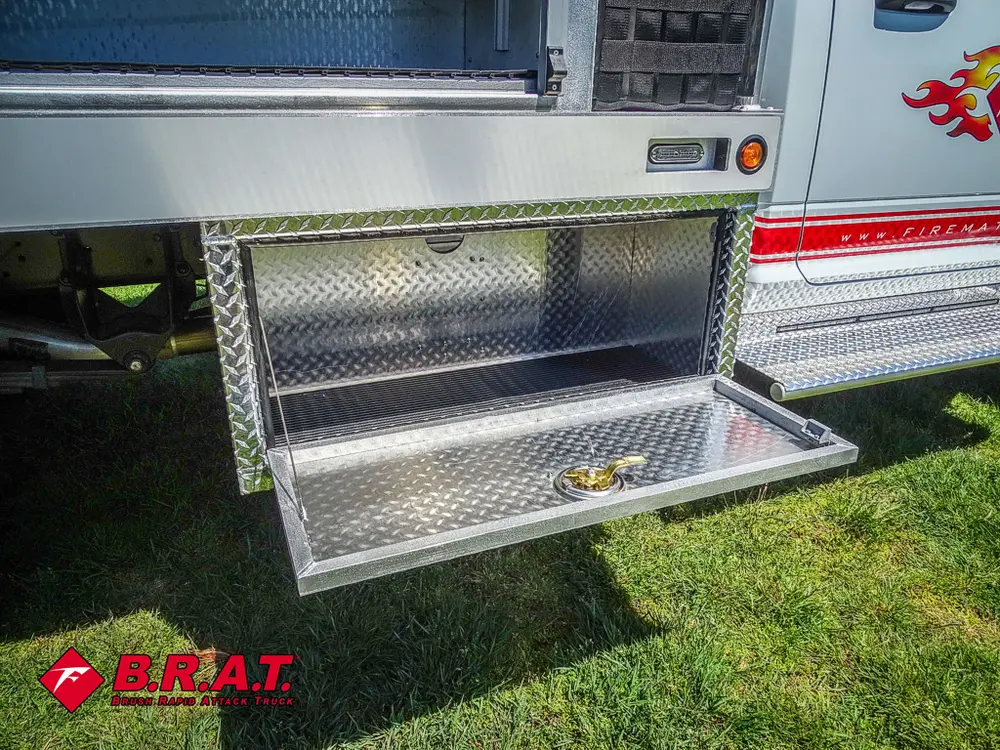 Open lower side compartment door with diamond-plate finish.