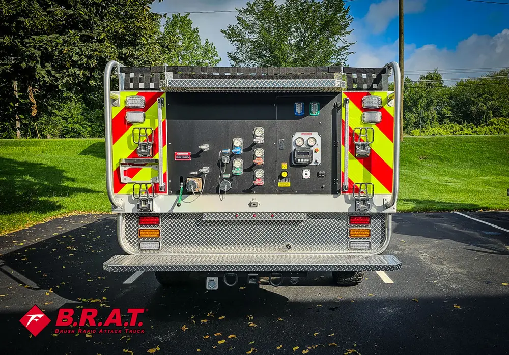 Straight rear view with pump control panel and chevron striping.