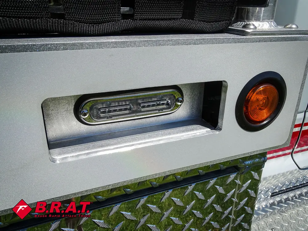 Rear bumper corner with marker lights and trim panel.