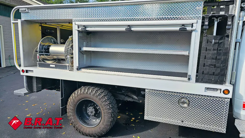 Passenger-side compartment bay open with shelf storage.