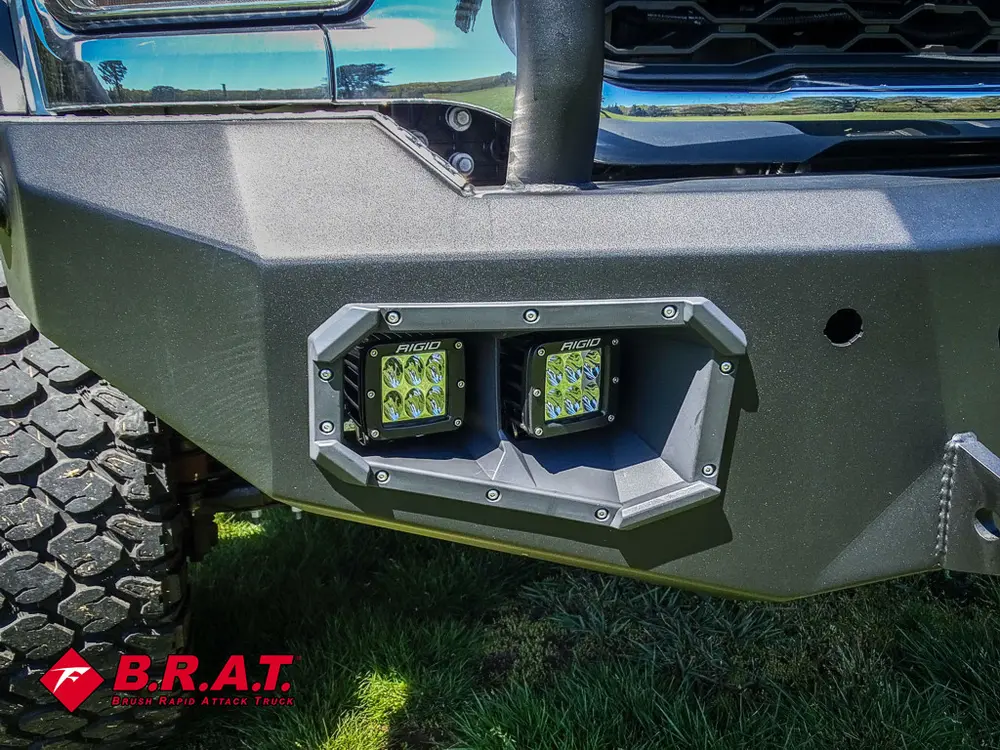 Front bumper auxiliary light pod close-up on textured mount.