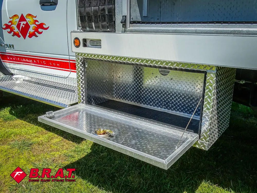 Open lower side compartment door beneath shelf bay.