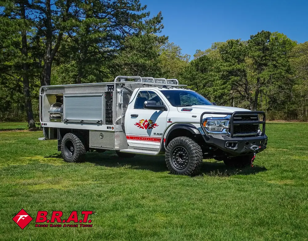 Driver-side three-quarter view parked on grass.