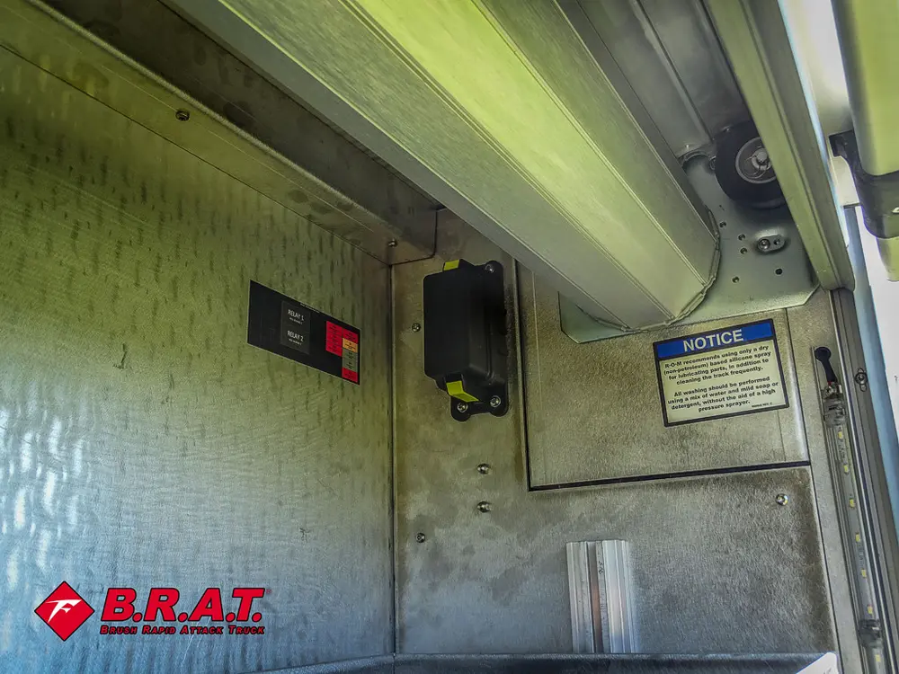 Compartment wall with digital display and warning label.