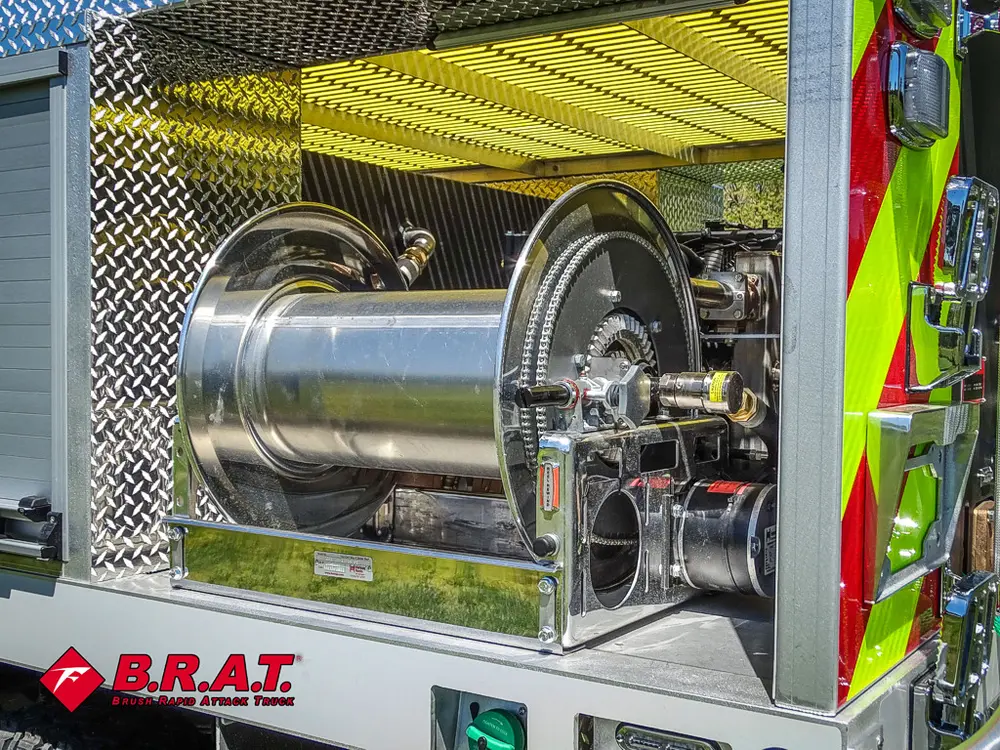 Side-mounted hose reel drum close-up near rear corner.