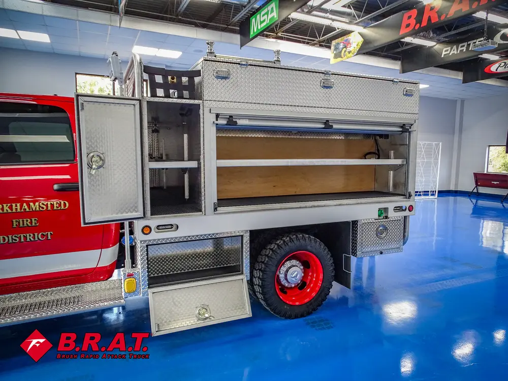 Passenger-side mid-body compartments open with shelves visible.