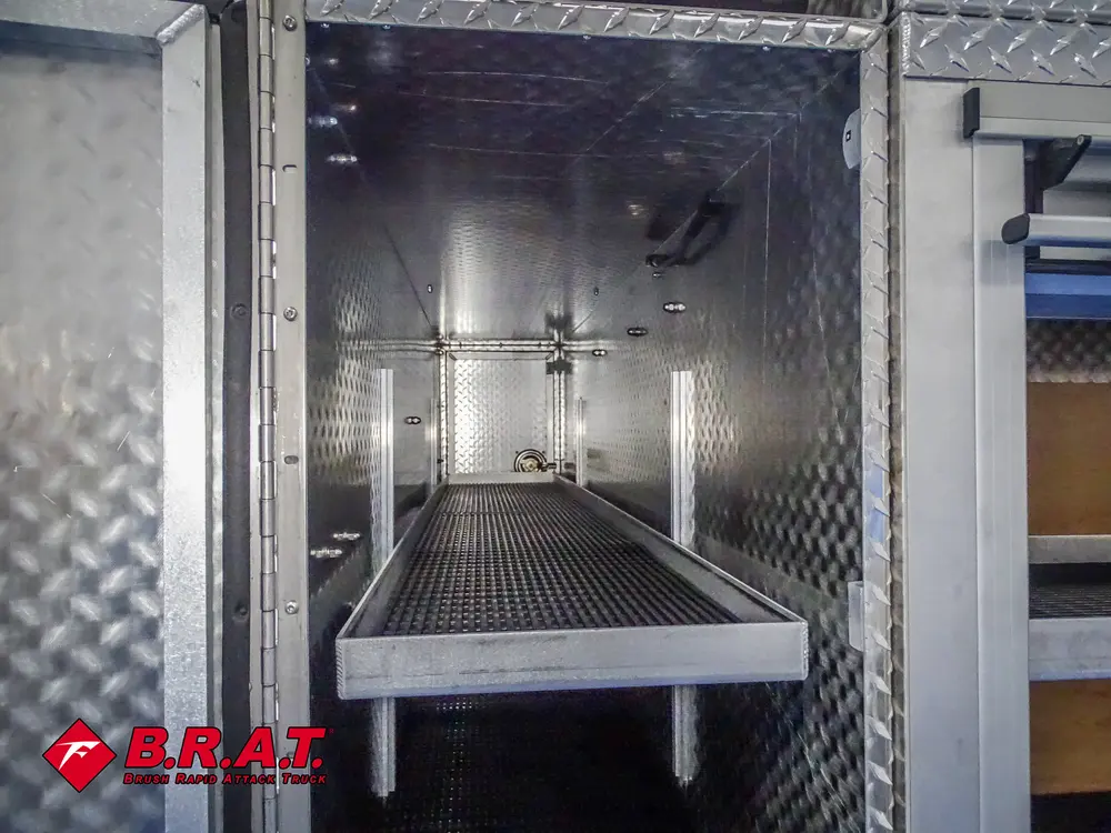 Tall open side compartment with shelf and black floor mat.