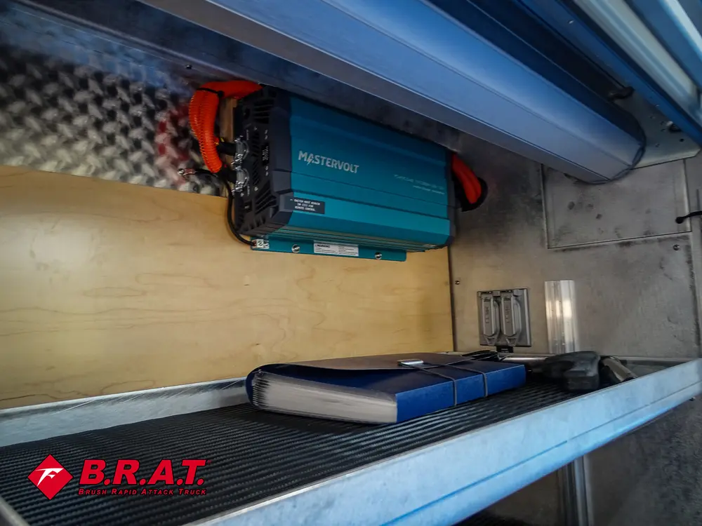 Long compartment close-up with mounted battery box and wiring.