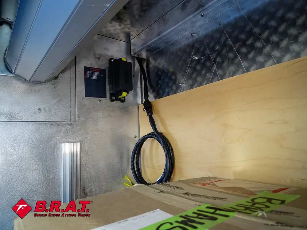 Compartment interior showing hose loop hanging from side wall.