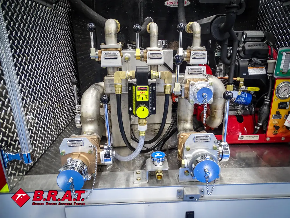 Pump panel close-up with gauges, valves, and hose couplings.