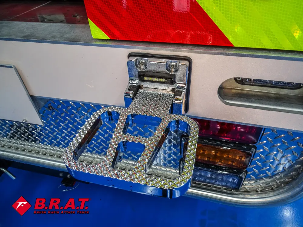 Rear bumper corner with fold-out step and taillight cluster.