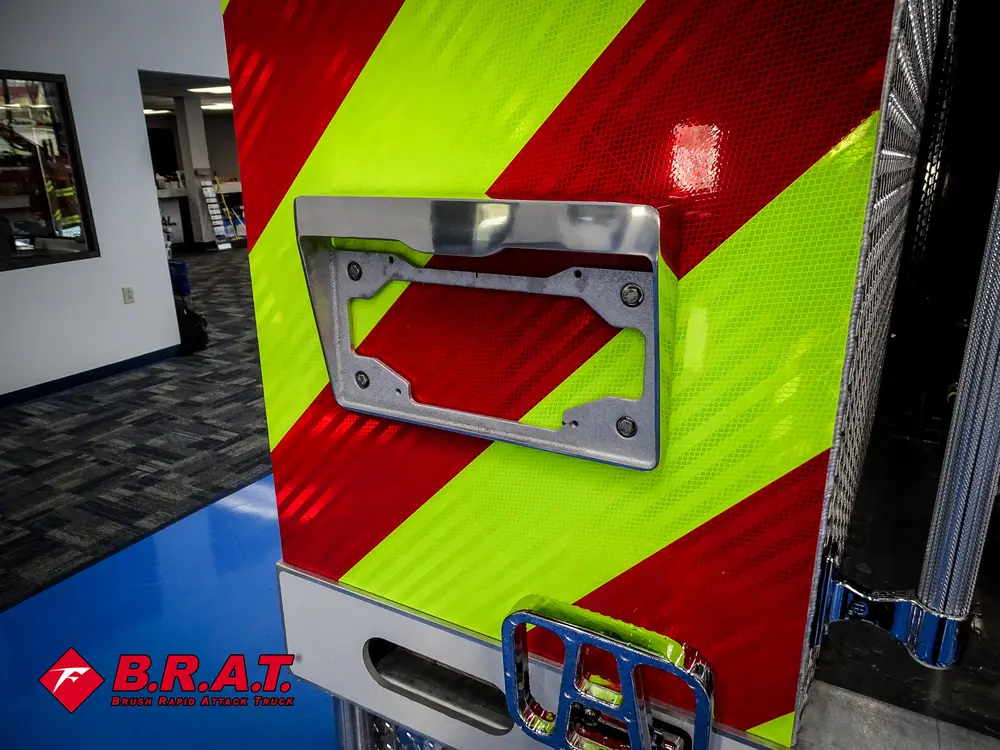 Open rear body compartment door with empty storage cavity.