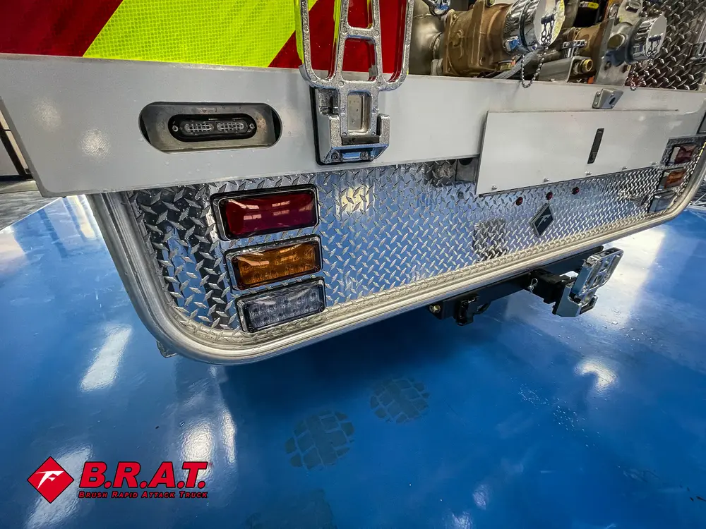 Rear passenger-side close-up showing marker lights and tow point.