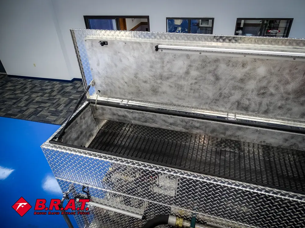 Second angle of open top storage box near hose reel.