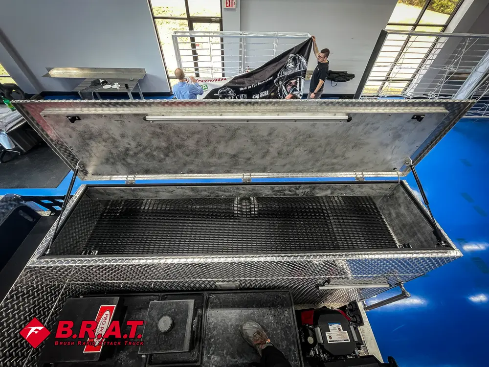 Raised lid over top storage box on rear deck.